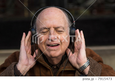 Senior man with eyes closed wearing headphones Senior man with eyes closed wearing headphones 7915473