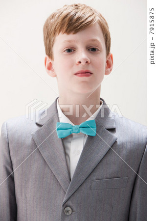 Boy wearing grey suit and bow tie, studio shot 7915875