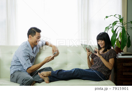 Couple relaxing in living room Couple relaxing in living room 7915901