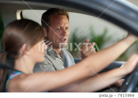 Father teaching teenage daughter driving Father teaching teenage daughter driving 7915966