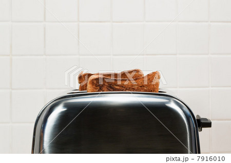 Two slices of toast in toaster 7916010