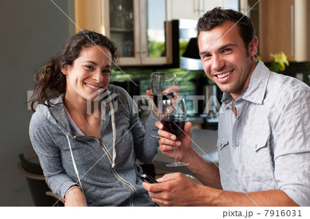 Young couple enjoying wine at home, portrait 7916031
