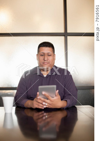 Mid adult man using digital tablet Mid adult man using digital tablet 7916561