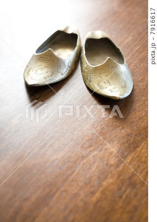 Pair of ethnic slippers on wooden floor 7916617