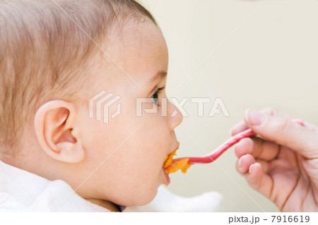 Baby boy being fed 7916619