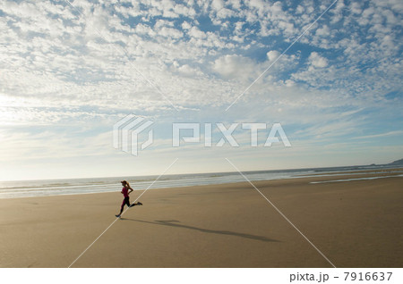 Young woman running on beach Young woman running on beach 7916637