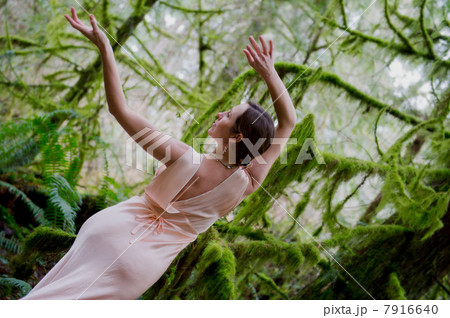 Mature woman dancing in forest 7916640