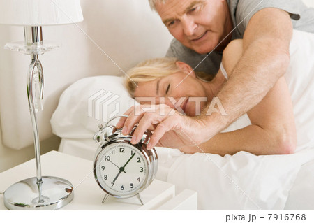 Man reaching to turn off alarm 7916768