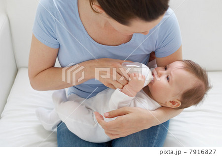 Mother bottle feeding baby 7916827