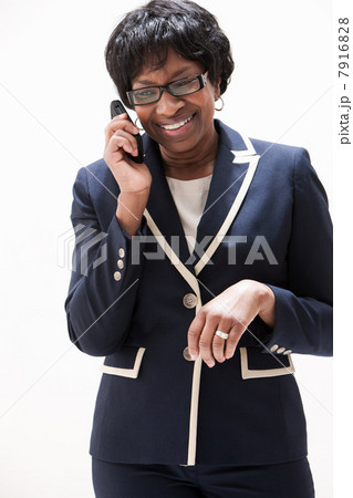Mature African American businesswoman using cellphone, studio shot 7916828