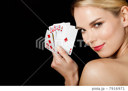Young blonde woman playing cards 7916971