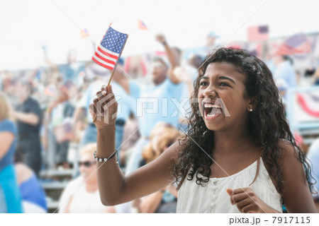 Girl cheering and waving american flag 7917115