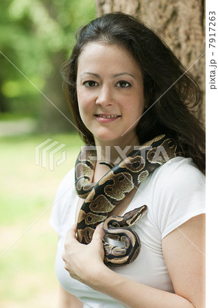Woman with a snake around her neck Woman with a snake around her neck 7917263