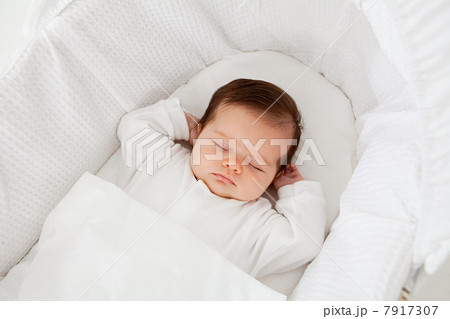 Baby sleeping in a bassinet 7917307