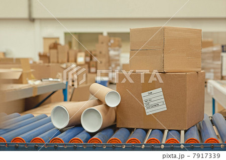 Cardboard boxes and tubes on conveyor belt 7917339