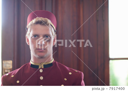 Bellhop with black eye in hotel lobby 7917400