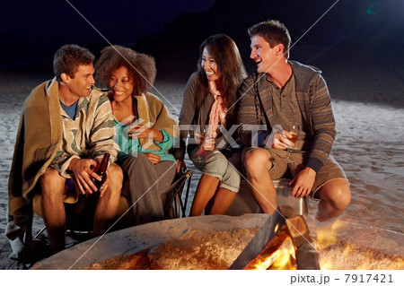 Friends having beach party at night Friends having beach party at night 7917421
