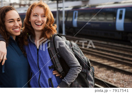 Young women smiling at train station 7917541
