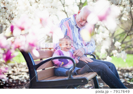 Grandfather and granddaughter together in park 7917649