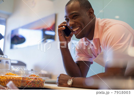 Cashier talking on cell phone in store 7918003