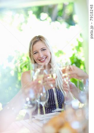 Woman toasting with champagne at table 7918248