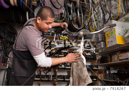 Mechanic working in bicycle shop Mechanic working in bicycle shop 7918267