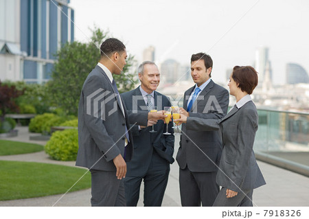 Businesspeople outdoors toasting with bucks fizz 7918326