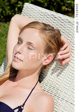 Young woman sleeping on sun lounger, close up Young woman sleeping on sun lounger, close up 7918469