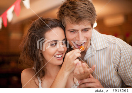 Couple tasting olives in grocery 7918561