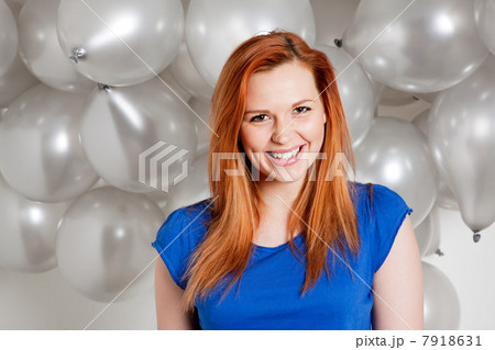 Happy young woman in front of balloons Happy young woman in front of balloons 7918631