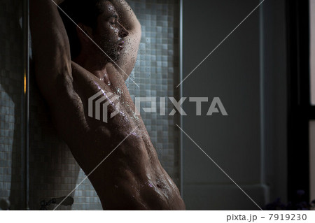 Mid adult male taking a shower Mid adult male taking a shower 7919230