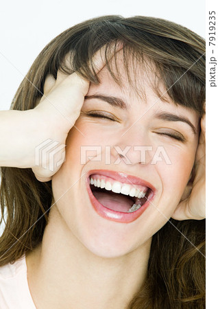 Portrait of young brunette woman with hands in hair 7919235