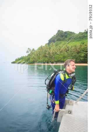 Scuba diver climbing into water 7919332