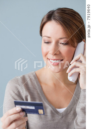 Young woman on the phone with credit card Young woman on the phone with credit card 7919640