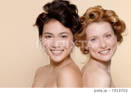 Two young women, one brunette and one redhead Two young women, one brunette and one redhead 7919703