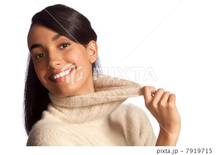 Young woman in polo neck smiling against white background 7919715