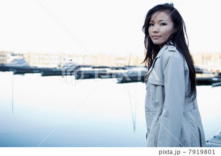Woman overlooking still lake 7919801