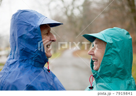 Senior couple face to face in waterproof clothing 7919841