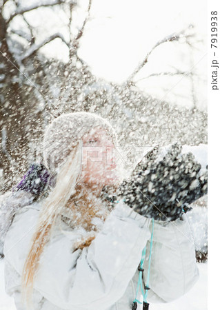 Mid adult woman playing in snow 7919938