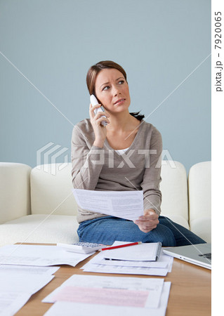 Young woman on the phone with paperwork Young woman on the phone with paperwork 7920065