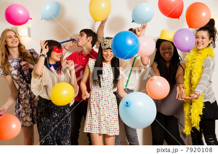 Friends at a party with balloons, studio shot 7920108