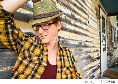 Young man wearing eyeglasses and fedora 7920586