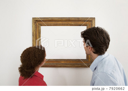 Young couple looking at blank image in picture frame Young couple looking at blank image in picture frame 7920662