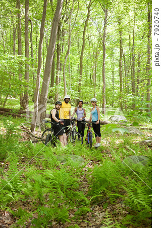Four cyclists in forest 7920740