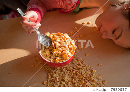 Young woman with spilt breakfast cereal Young woman with spilt breakfast cereal 7920837