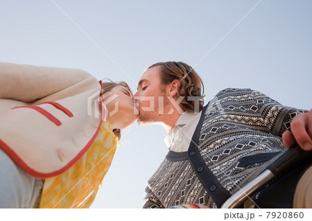 Low angle view of young couple kissing Low angle view of young couple kissing 7920860
