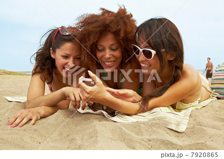 Young women sunbathing on beach Young women sunbathing on beach 7920865