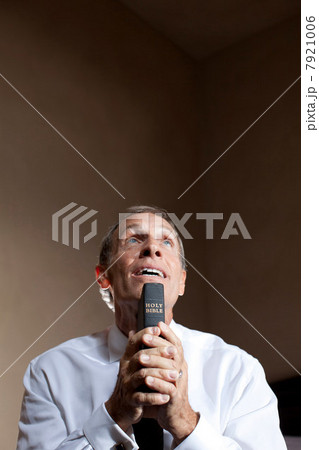 Older man holding bible Older man holding bible 7921006