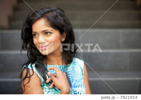 Smiling woman standing on steps 7921054