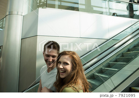 Young couple travelling on escalator 7921095